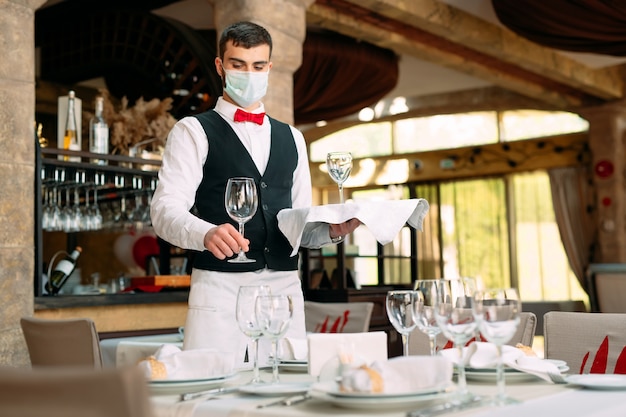 Download Free A Waiter In A Medical Protective Mask Serves The Table In The Use our free logo maker to create a logo and build your brand. Put your logo on business cards, promotional products, or your website for brand visibility.