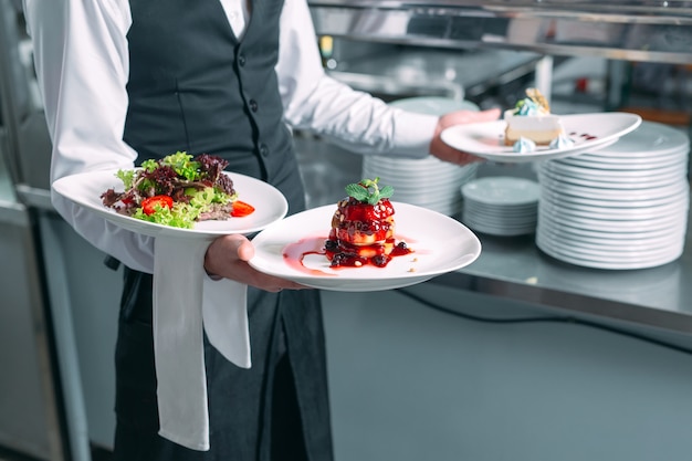 Premium Photo | Waiter serving in motion on duty in restaurant. the ...