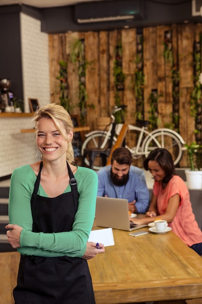 Premium Photo | Waitress standing with arms crossed