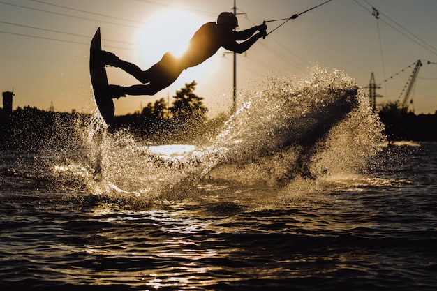 Wakeboard. wakeboarding jumping at sunset Free Photo