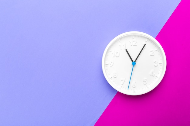 Premium Photo | Wall clock on color background