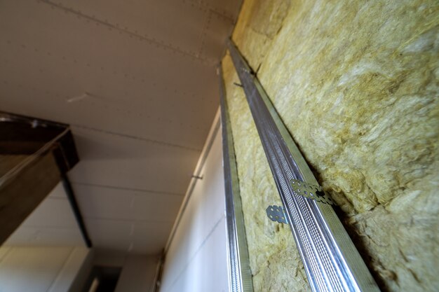 Premium Photo Wall Of A Room Under Renovation With Mineral Rock Wool Insulation And Metal Frame Prepared For Drywall Plates