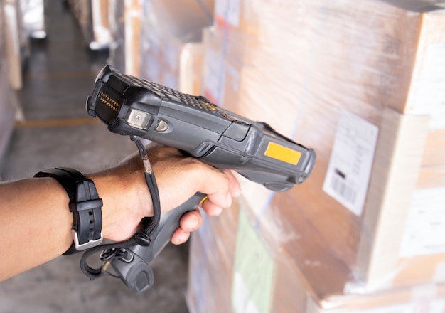 Premium Photo | Warehouse worker is scanning barcode scanner with the ...