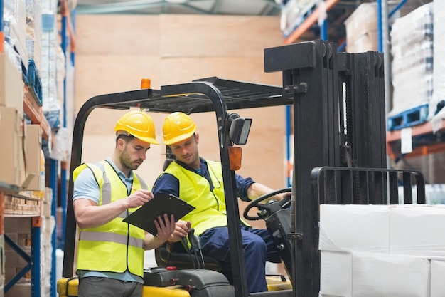 Premium Photo Warehouse Worker Talking With Forklift Driver