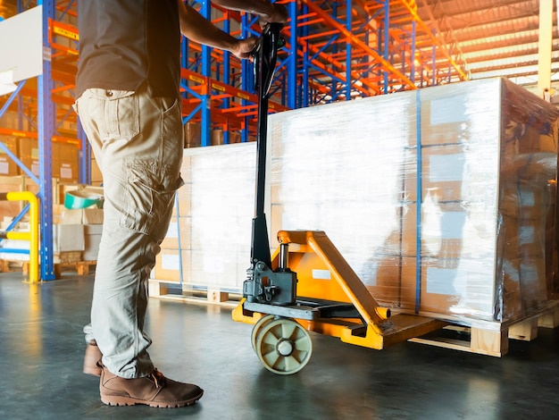 premium-photo-warehouse-worker-with-hand-pallet-truck-unloading