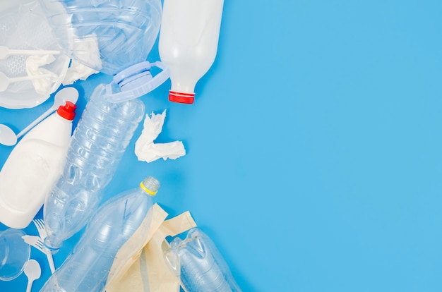 Free Photo | Waste plastic trash and crumpled paper over blue background