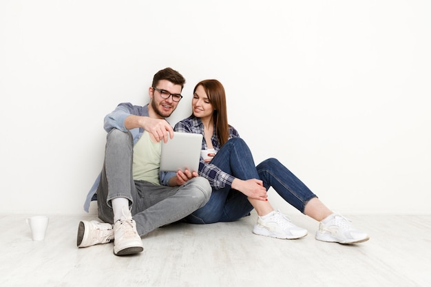 Premium Photo | Wasting money for shopping. couple at home sitting on ...