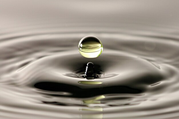 Premium Photo | Water drop close up into a beautiful shape.