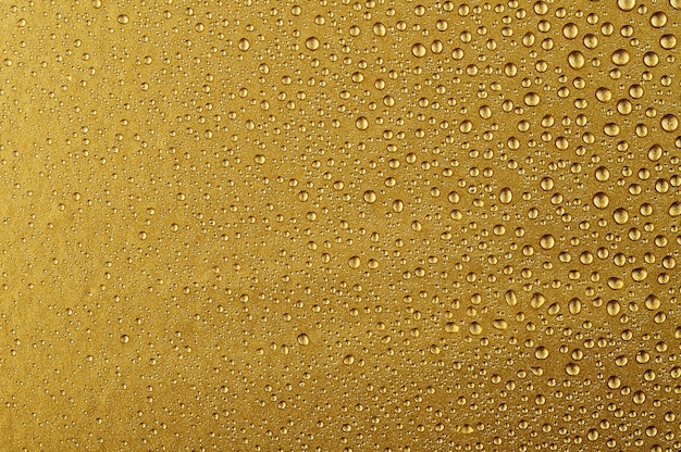 Premium Photo | Water drops on a gold background