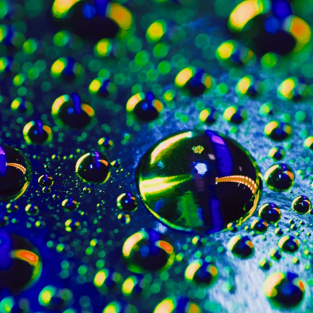 Free Photo | Water drops on the surface with a shiny colorful reflection