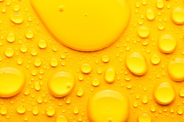 Premium Photo | Water drops on a yellow background