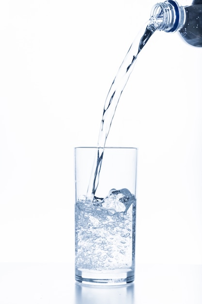 Premium Photo | Water pouring in glass isolated on white background
