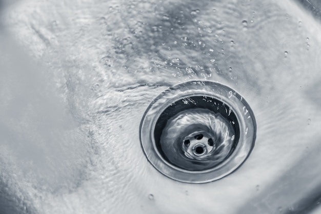 Premium Photo | Water rinse in kitchen stainless steel sink hole