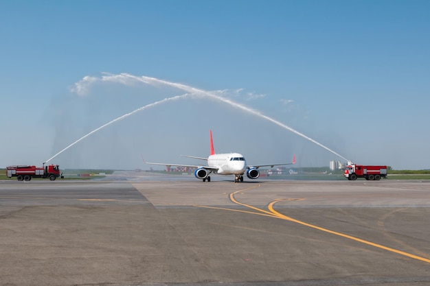 Premium Photo | Water salute by fire truck at the airport for first ...