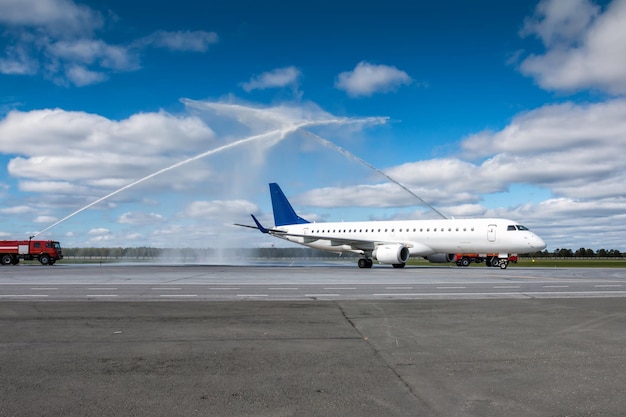 Premium Photo | Water salute by fire truck at the airport for first ...