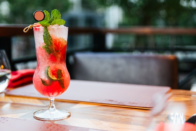 Premium Photo Watermelon Cocktail Mixed With Kaffir Lime Served In Drinking Glass With Ice On Wooden Table With Copy Space