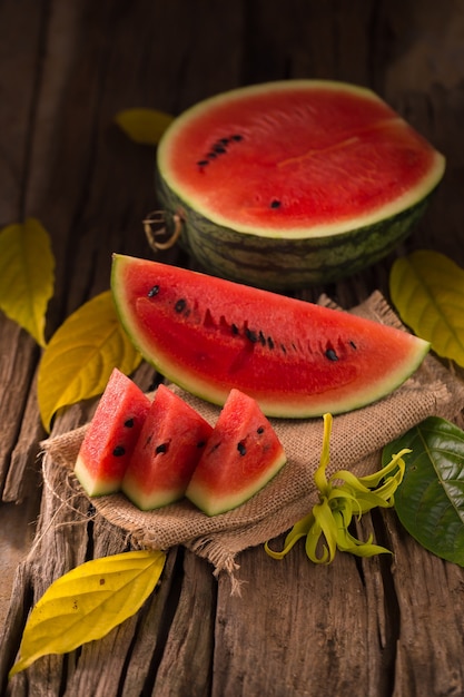 Premium Photo | Watermelon slice on a rustic wood background