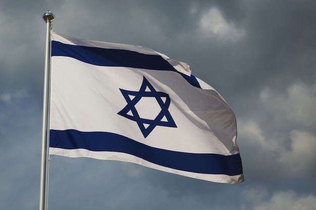 Premium Photo | Waving colourful flag of israel against cloudy sky