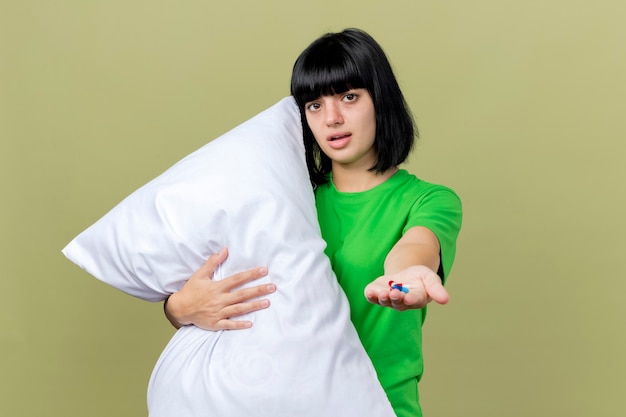 Free Photo | Weak young ill woman holding pillow looking at front ...