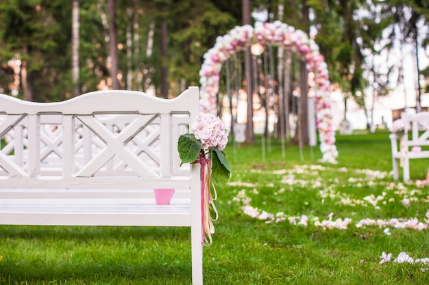 Premium Photo | Wedding benches and flower arch for ceremony outdoors