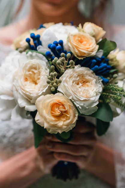 Premium Photo Wedding Bouquet Of White Peonies And Yellow Roses In The Hands Of The Bride