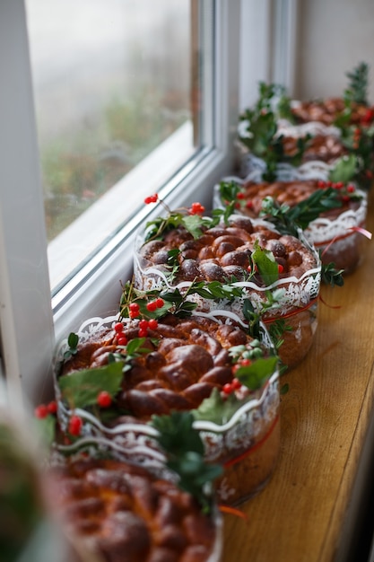 Wedding Breads Decorated With Green Leaves And Berries Stand On