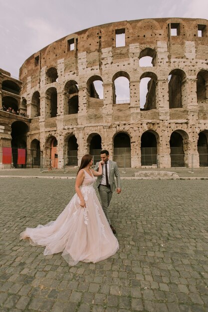 Wedding Couple Near Colosseum In Rome Italy Premium Photo
