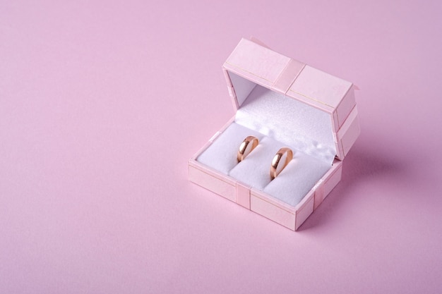 Premium Photo | Wedding gold rings in pink gift box on soft pink ...