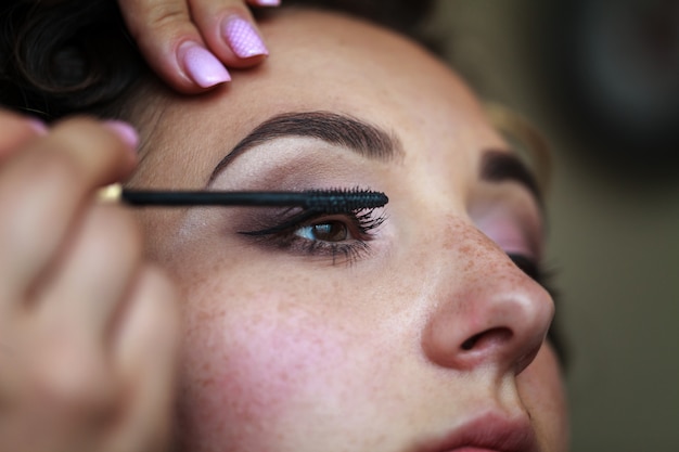 Wedding makeup artist making a make up for bride Premium Photo