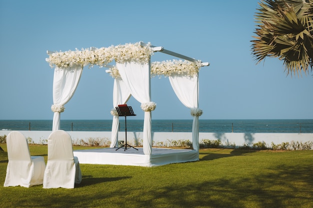Wedding pavilion set for an outdoor garden wedding by the sea Free Photo