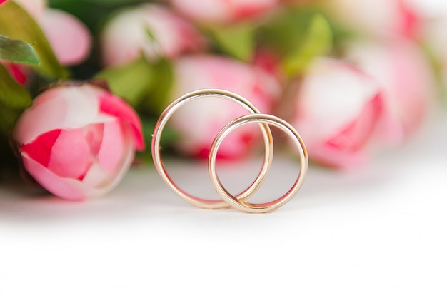 Premium Photo | Wedding rings and flowers isolated on white background