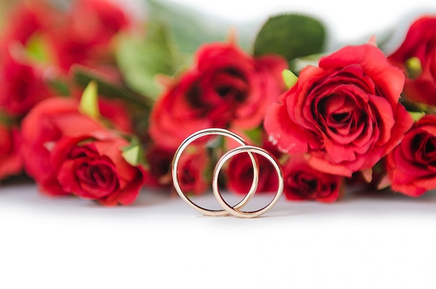 Premium Photo | Wedding rings and flowers isolated