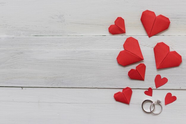 Wedding Rings And Red Heart Origami Paper On White