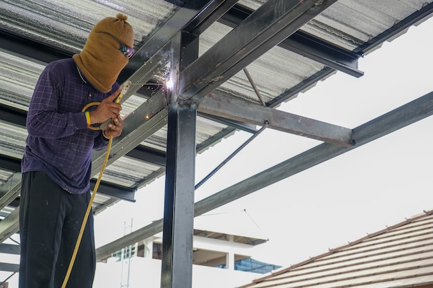 Premium Photo | Welders are welding steel roof frame of home