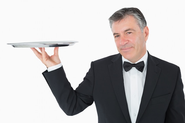 Premium Photo | Well-dressed waiter holding a silver tray