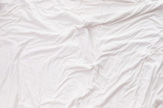 Premium Photo White bedding sheet texture background.