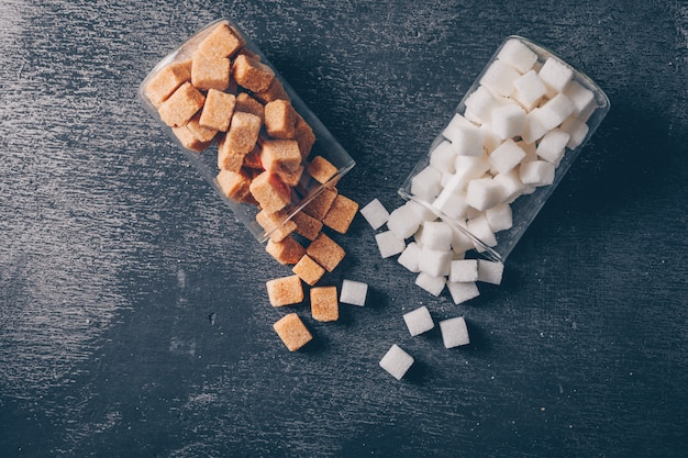 White and brown sugar in water glasses flat lay Free Photo