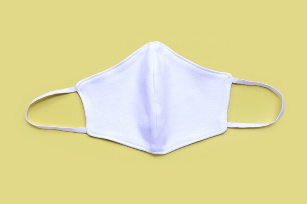 Premium Photo | White cloth mask on yellow background.