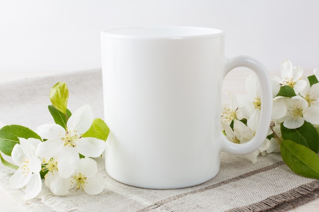 Download White coffee mug mockup with apple blossom Photo | Premium ...