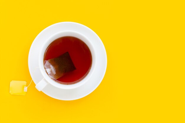 Premium Photo | White cup of tea on yellow background