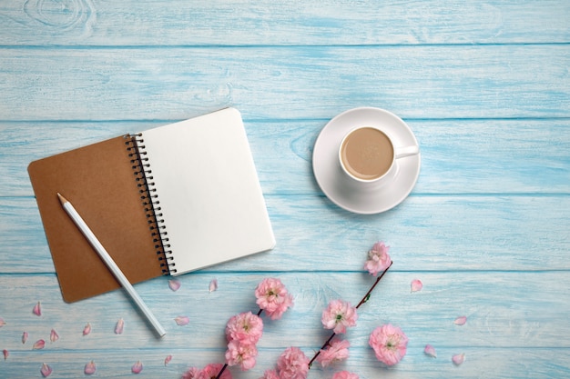 Download Free White Cup With Cappuccino Sakura Flowers And Notebook On A Blue Use our free logo maker to create a logo and build your brand. Put your logo on business cards, promotional products, or your website for brand visibility.