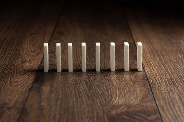 Premium Photo | White domino on brown wood