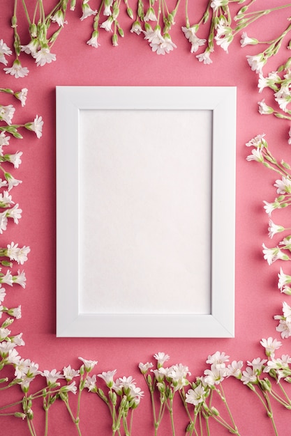 Premium Photo | White empty photo frame with mouse-ear chickweed ...