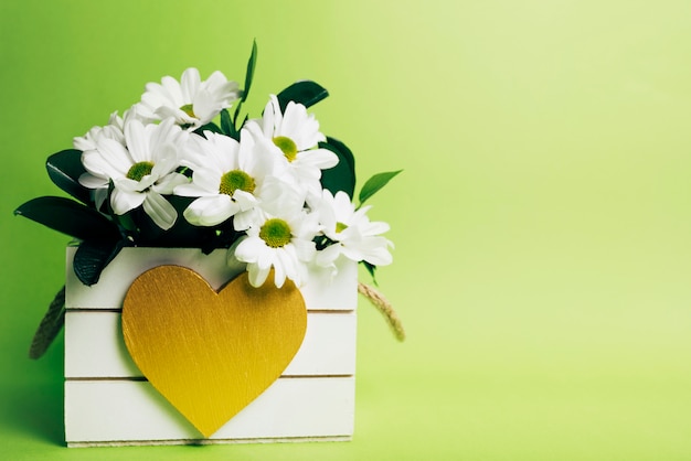 White Flower Vase With Heart Shape On Green Background Free Photo