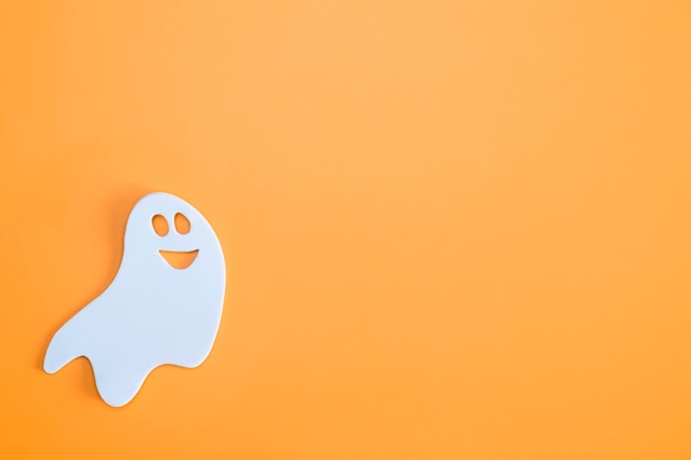 Premium Photo | White ghost on an orange background