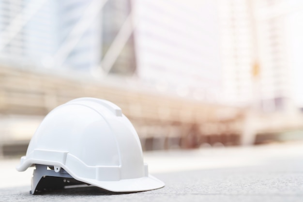 Premium Photo | White hard safety wear helmet hat in the project at ...