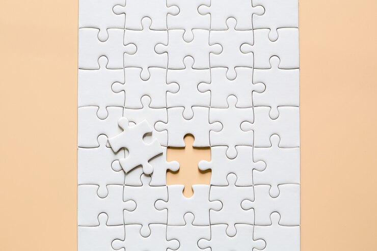 Free Photo | White jigsaw puzzle pieces on pink