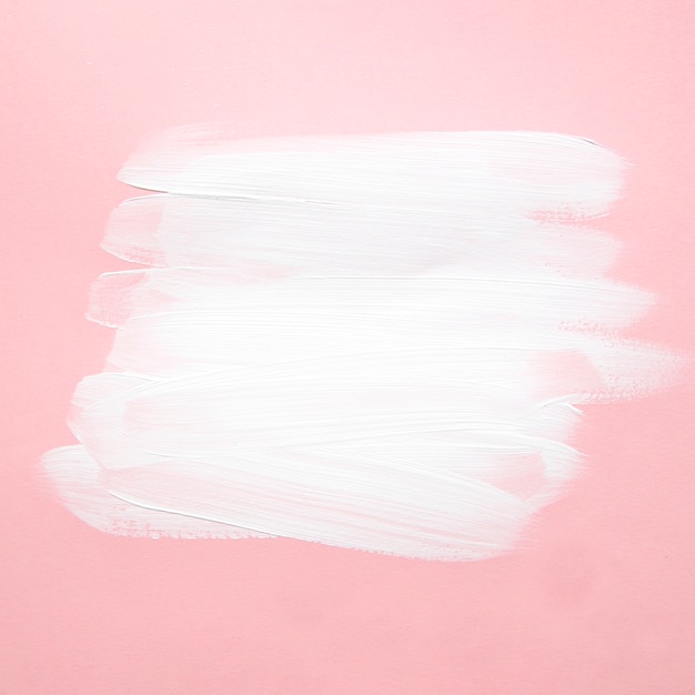 Premium Photo | White paint flakes on pink