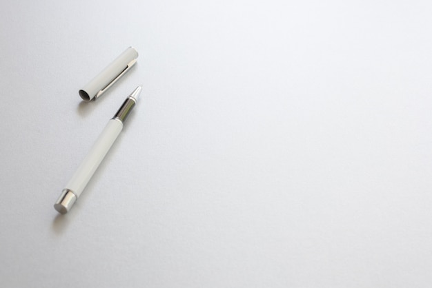 Free Photo A White Pen Isolated On White Writing Paper Background