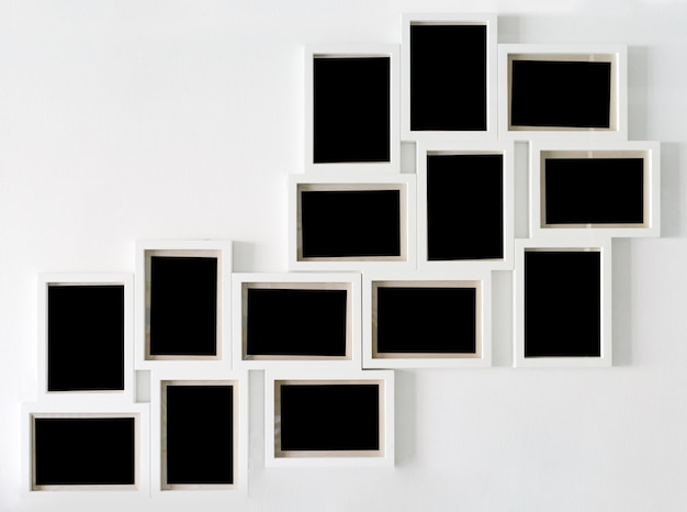 Premium Photo | White picture frame and black decorative hanging on ...